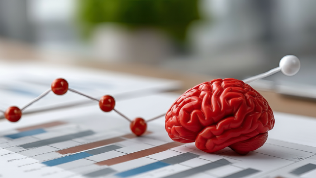 Rotes Gehirnmodell liegt auf einem Forschungsbericht.